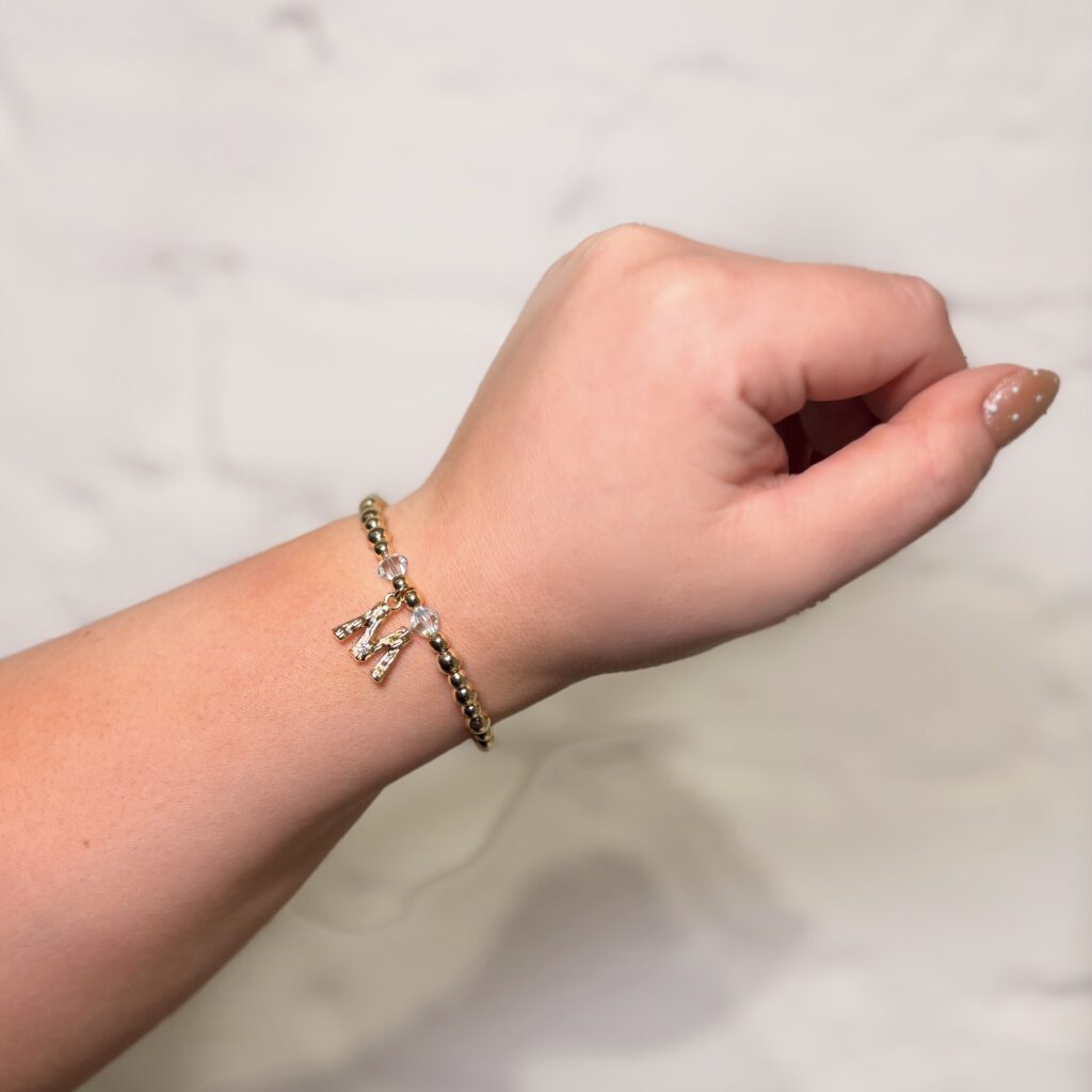Gold beaded stretch bracelet with crystal accents and dangling initial charm