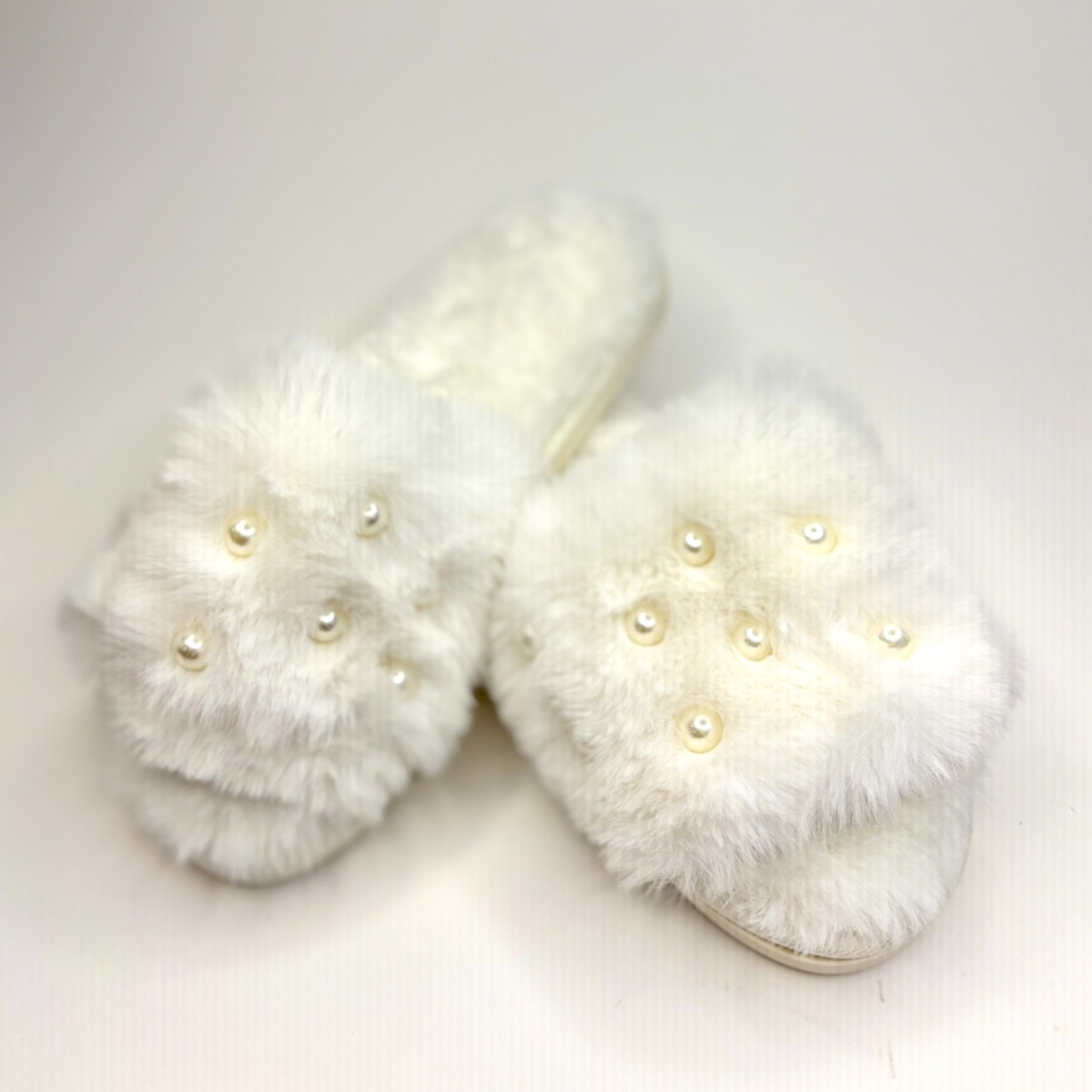 pearl-adorned bridal slippers.