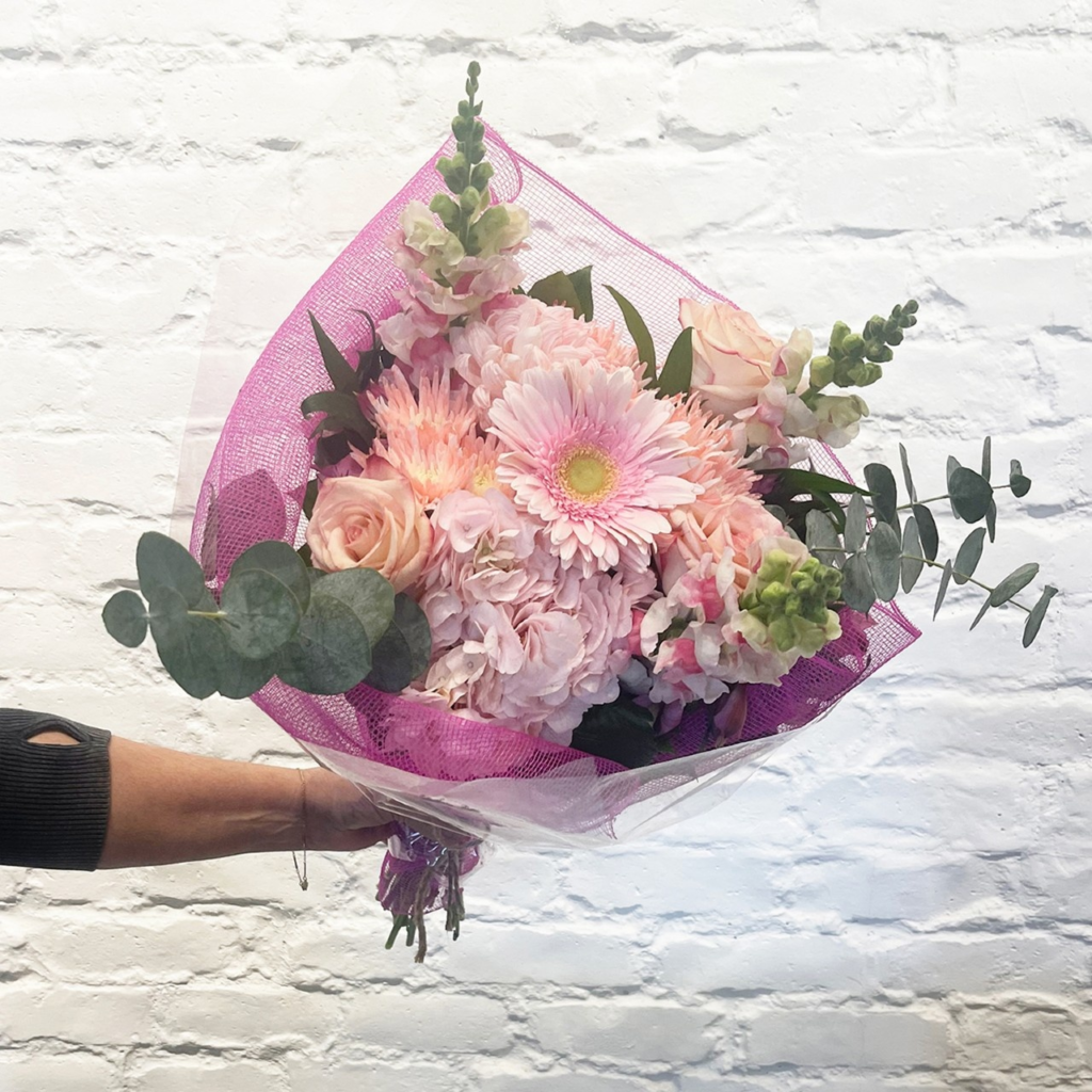 Fluffy hydrangeas, long-lasting commercial mums, beautiful roses, poms, alstroemeria, disbud and snapdragons, accented with lush eucalyptus and salal.
