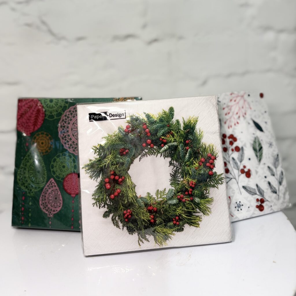 Festive Christmas napkins with wreath, berry and classic holiday patterns.