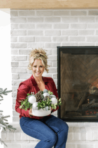 Krissy Thiessen holding christmas arrangement