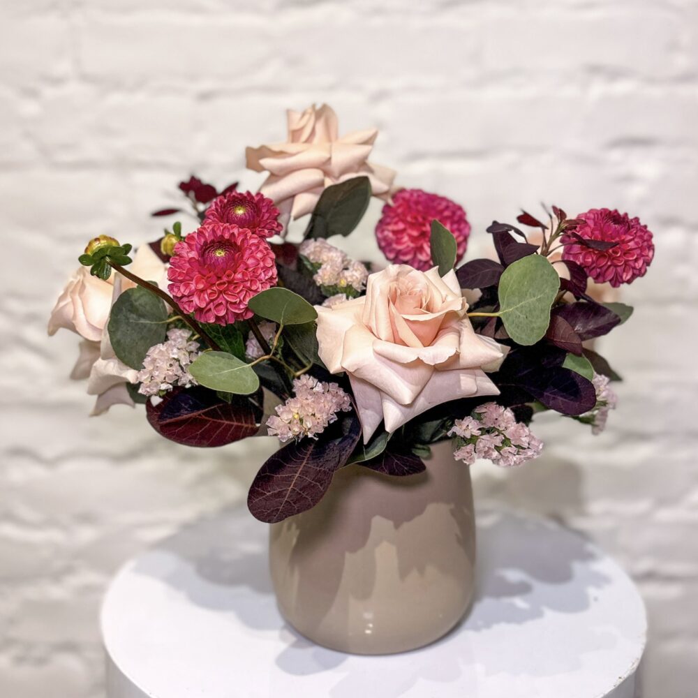 Burgundy Beauty flower arrangement with blush roses, pink dahlias, statice, smokebush and fresh greens