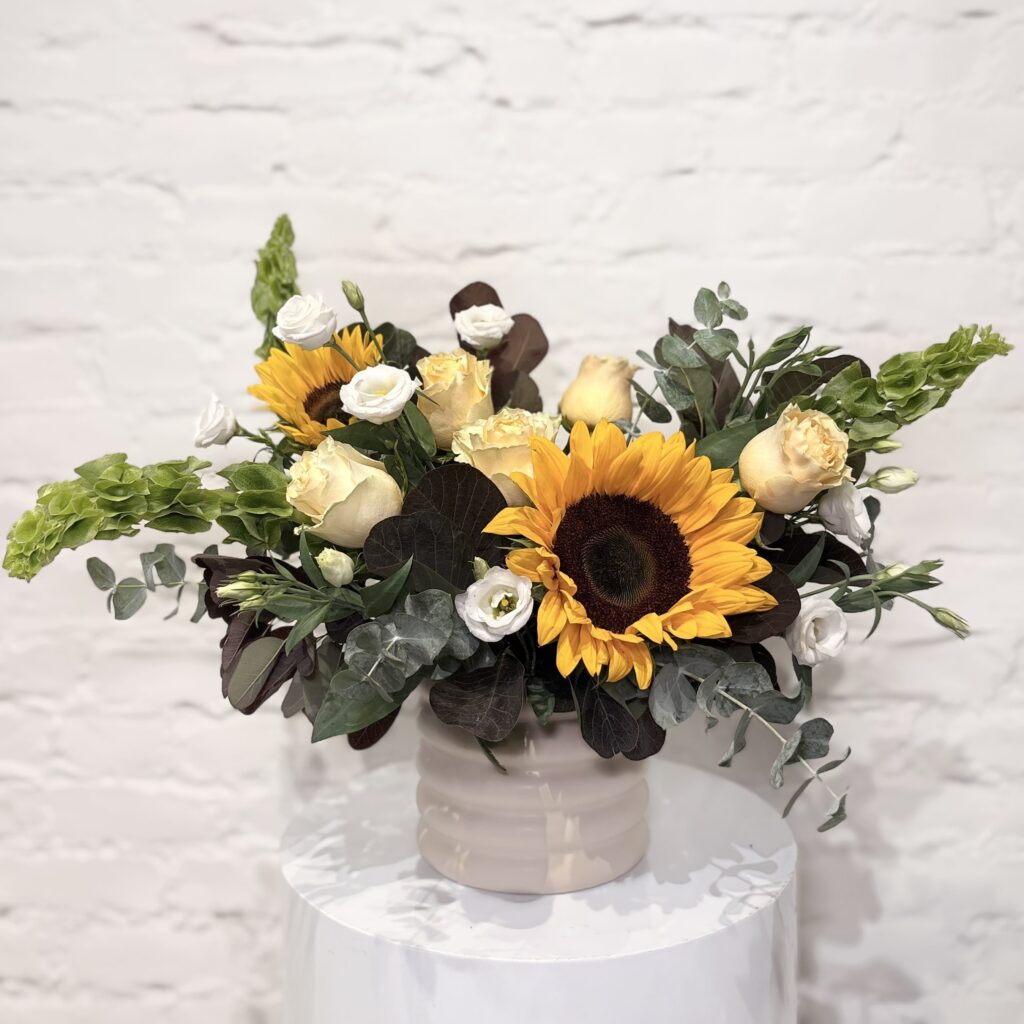 Homegrown flower arrangement with sunflowers, roses, lisianthus, Belles of Ireland, smokebush and fresh greens